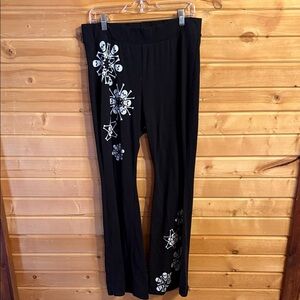 Torrid Black Leggings with Skeleton Design & flare bottoms